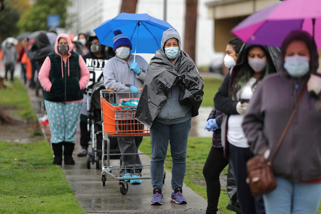 People queue to pick up fresh food at a Los Angeles Regional Food Bank giveaway of 2,000 boxes of groceries, as the spread of the coronavirus disease (COVID-19) continues, in Los Angeles, California, U.S., April 9, 2020.
