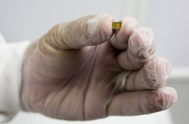 A nano Bible is displayed at TowerJazz Semiconductor in Migdal Haemek in northern Israel October 29, 2014. The nano sized New Testament developed by an Israeli company has been nominated for the Guinness Book of Records as the World's Smallest Bible, the company said on Tuesday. Jerusalem nano Bible company said it developed a chip smaller than five by five millimetres, which contains the original Greek version of the New Testament (Textus Receptus, or "received text" in Latin). Picture taken October 29, 2014. REUTERS/Amir Cohen (ISRAEL - Tags: RELIGION SCIENCE TECHNOLOGY TPX IMAGES OF THE DAY)