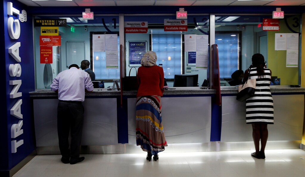 Customers make transactions inside a Chase Bank branch, now managed by Kenya Commercial Bank (KCB), after its reopening in in Kenya's capital Nairobi, April 27, 2016.