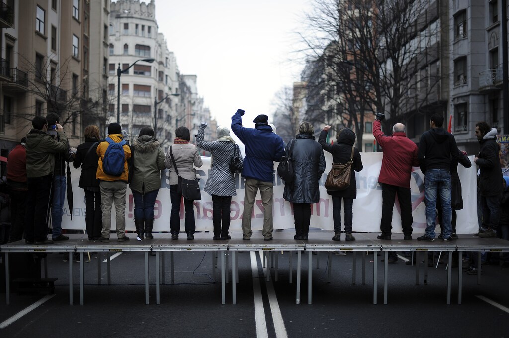 Members of public sector unions raise their fists as they sing "L'Internationale" during a march in central Bilbao February 9, 2012.