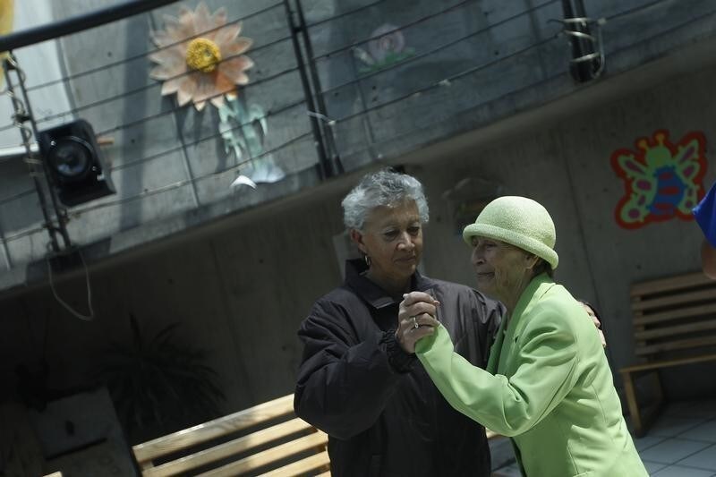 Two women, patients with Alzheimer's and dementia, dance inside the Alzheimer foundation in Mexico City April 19, 2012. Alzheimer's is a progressive, degenerative disease that robs people of memory, reasoning and the ability to communicate. About 24 million people worldwide have the disease according to the World Health Organization. In Mexico, 600,000 Mexicans out of 9 million adults over the age 60 suffer from Alzheimer's, according to the Institute of Geriatrics (INGER). Picture taken April 19, 2012.