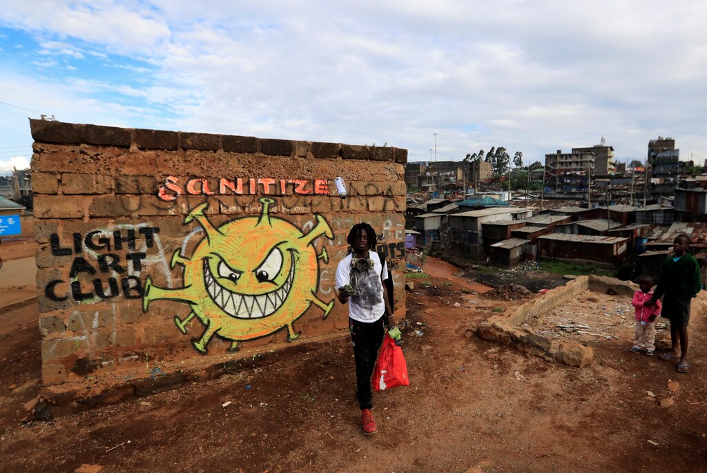 Brian Musasia Wanyande, an artist from the Mathare Roots's youth group, walks away after painting an advocacy graffiti against the spread of the coronavirus disease in Mathare, Nairobi, Kenya, April 2020.