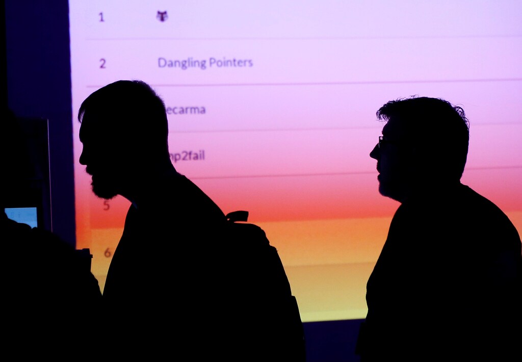 Participants are silhouetted as they pass through the IOT (Internet of Things) Village during the Def Con hacker convention in Las Vegas, Nevada, U.S. on July 29, 2017. REUTERS/Steve Marcus - RC1DF66ECED0