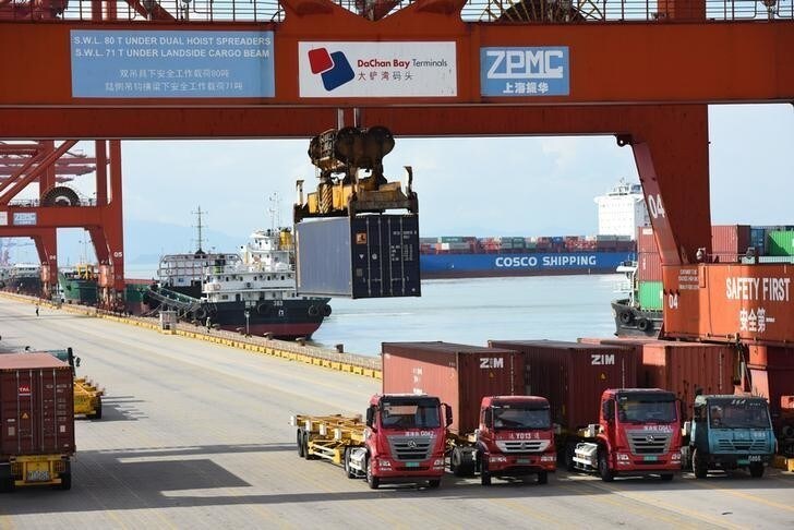 Shipping containers and cargo vessels are seen at the Dachan Bay Terminals in Shenzhen, Guangdong province, China July 12, 2018. REUTERS/Stringer ATTENTION EDITORS - THIS IMAGE WAS PROVIDED BY A THIRD PARTY. CHINA OUT.