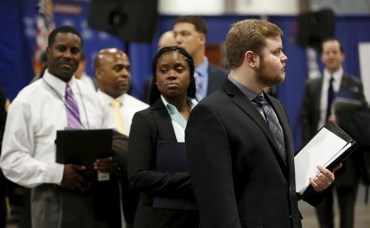 Job applicants await their turn at the Lockheed Martin booth at a U.S. Chamber of Commerce Foundation "Hiring Our Heroes" military job fair in Washington January 8, 2016. U.S. job growth surged in December and employment for the prior two months was revised sharply higher, suggesting that a recent manufacturing-led slowdown in economic growth would be temporary. Nonfarm payrolls increased by 292,000 last month, the Labor Department said on Friday. REUTERS/Gary Cameron