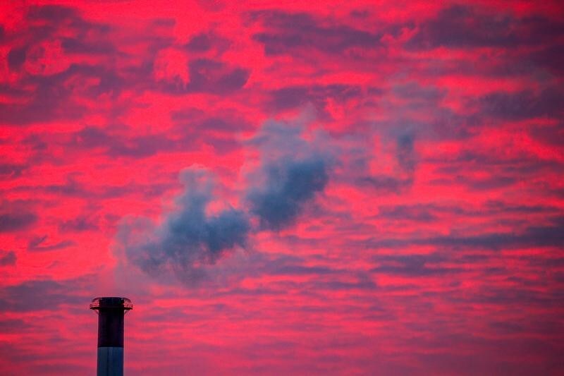 Steam rises from a smoke stack at sunset in Lansing, Michigan, U.S., January 17, 2018. REUTERS/Brendan McDermid - RC1DFC5BF8A0