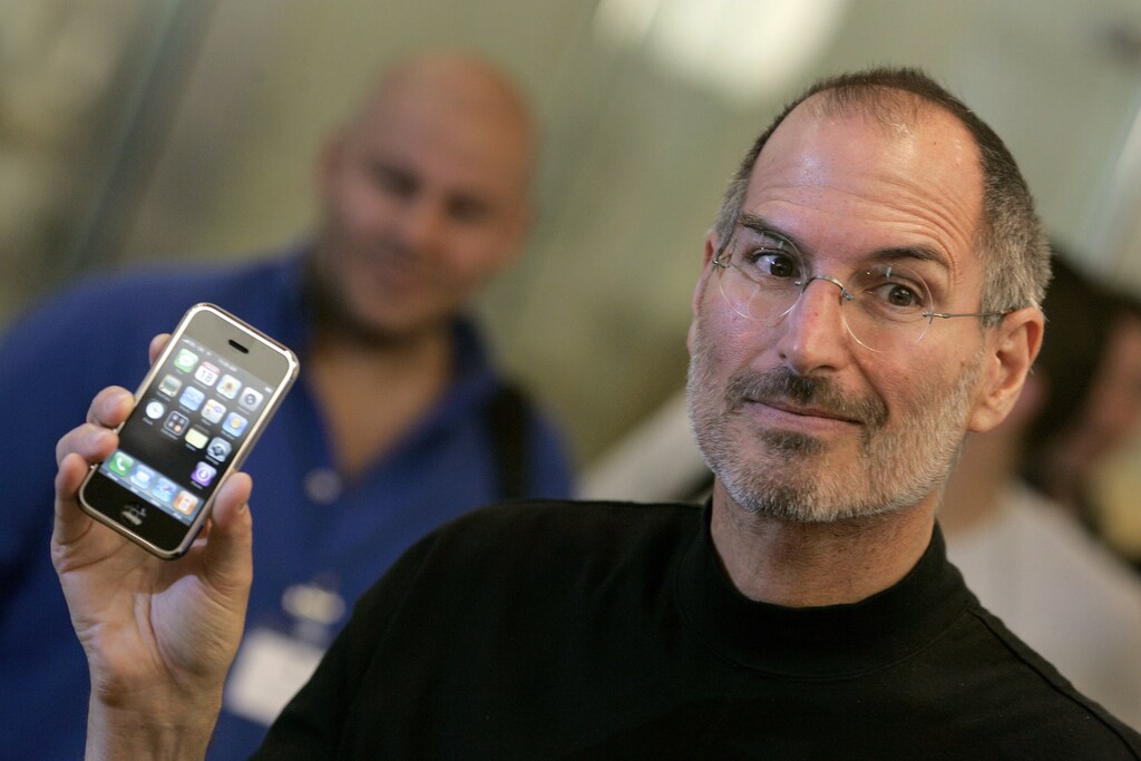 Apple Chief Executive Steve Jobs holds the new iPhone at the Apple store in central London.
