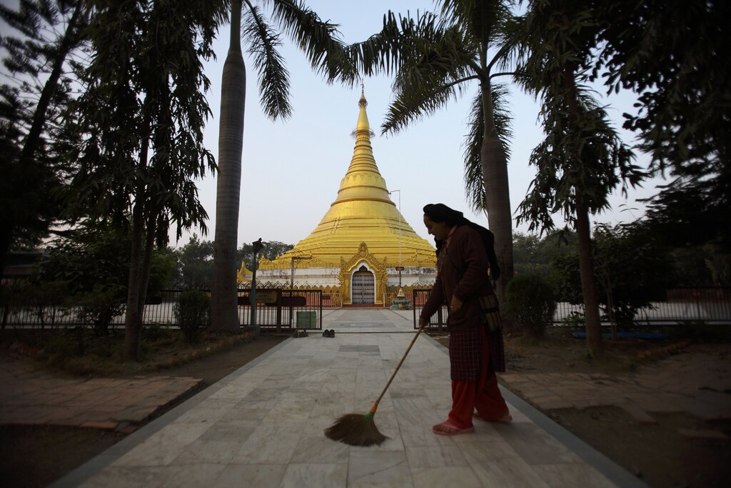 A woman is seen sweeping the floor of Myanmar Golden Temple in Lumbini, south-west of Kathmandu, Nepal.