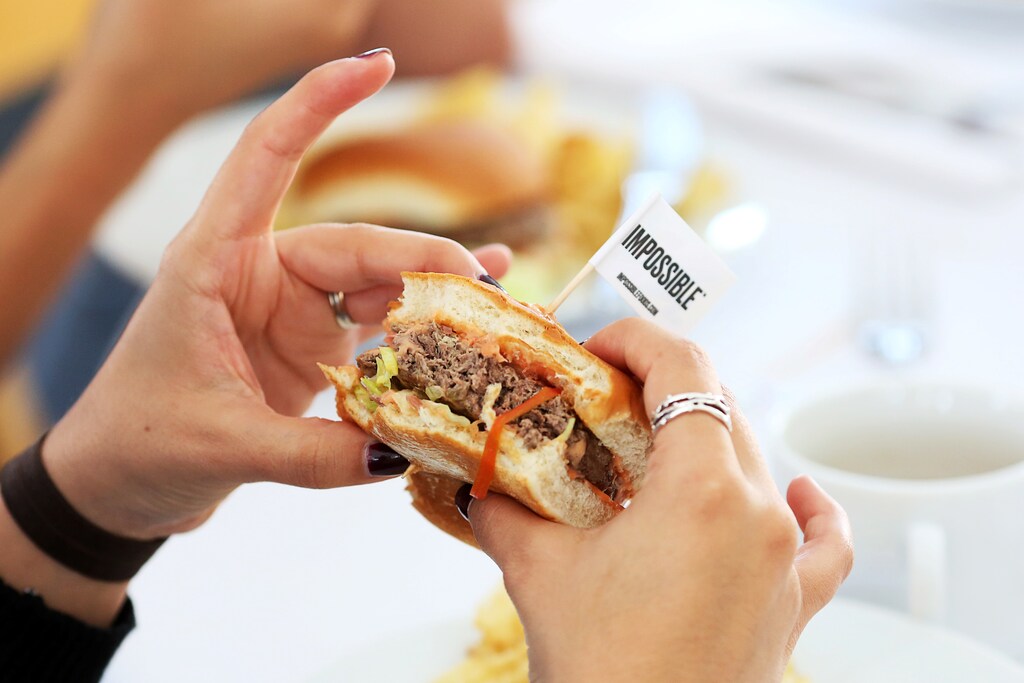 Journalists taste test the plant based hamburgers during a media tour of Impossible Foods labs and processing plant in Redwood City, California, U.S. October 6, 2016. Picture taken October 6, 2016. REUTERS/Beck Diefenbach - S1BEUGSRCSAB