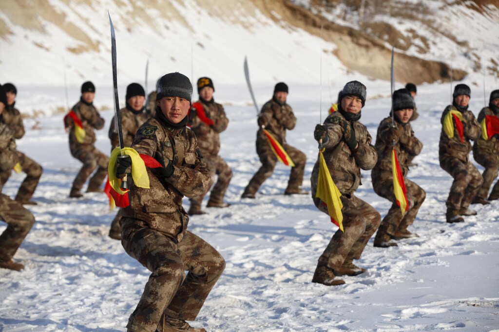 Soldiers of China's People's Liberation Army (PLA) take part in winter training at temperatures around negative 30 degrees Celsius (minus 22 degrees Fahrenheit) at China's border with Russia in Heihe, Heilongjiang province, January 31, 2016. REUTERS/China Daily ATTENTION EDITORS - THIS PICTURE WAS PROVIDED BY A THIRD PARTY. THIS PICTURE IS DISTRIBUTED EXACTLY AS RECEIVED BY REUTERS, AS A SERVICE TO CLIENTS. CHINA OUT. NO COMMERCIAL OR EDITORIAL SALES IN CHINA. - RTX24UU0