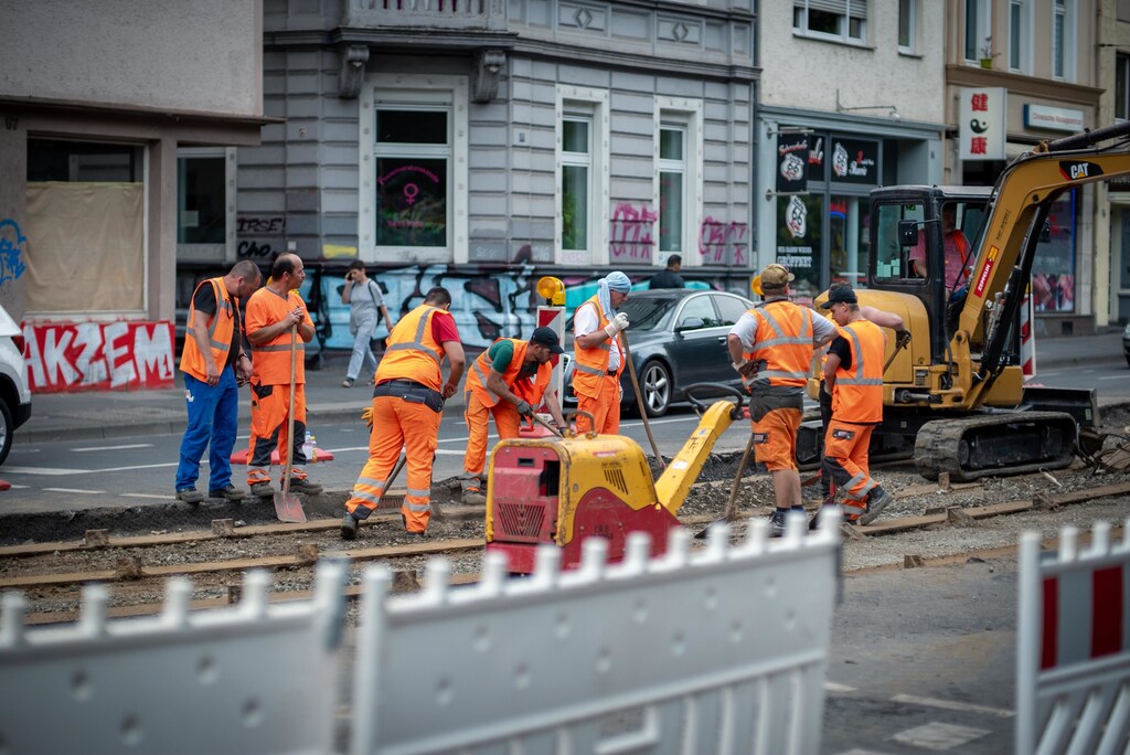 Construction workers digging up a road