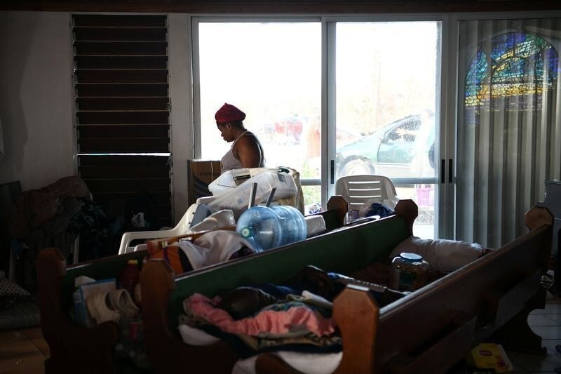 Abaco residents pass the time at a damaged church serving as a shelter for people who lost their homes to Hurricane Dorian in Marsh Harbour, Great Abaco, Bahamas, September 8, 2019. REUTERS/Loren Elliott - RC162E8F48A0