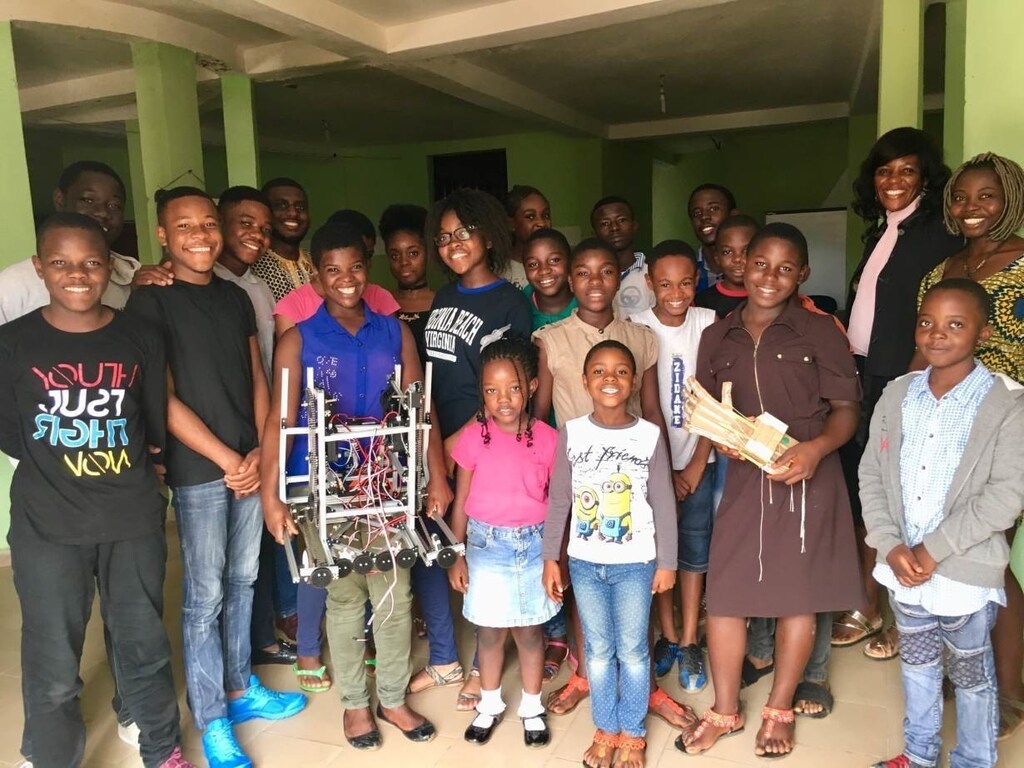 Janet Fofang and the robotics team pose for a photo in the NextGen Centre with the robot they have assembled in Yaounde, Cameroon on July 11, 2018. Thomson Reuters Foundation/Inna Lazareva