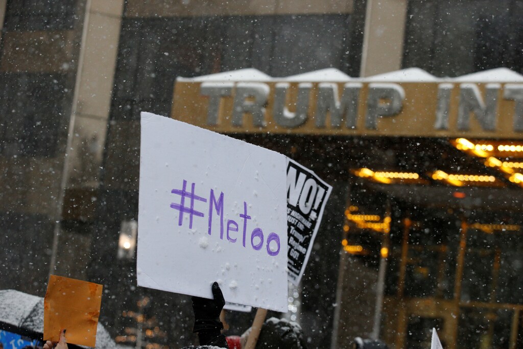 Protest signs are raised at #MeToo demonstration outside Trump International hotel in New York City, NY, U.S., December 9, 2017. REUTERS/Brendan McDermid - RC1939B6C700