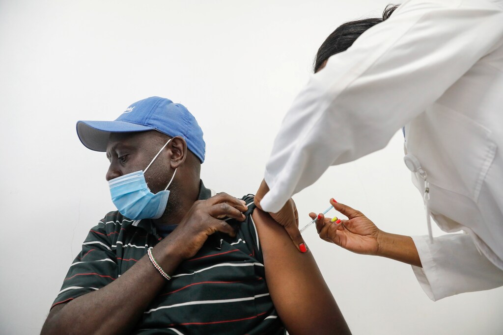 A medical worker gives a dose of AstraZeneca's coronavirus disease (COVID-19) vaccine to a man, at the Ruaraka Uhai Neema Hospital in Nairobi, Kenya, April 8, 2021.