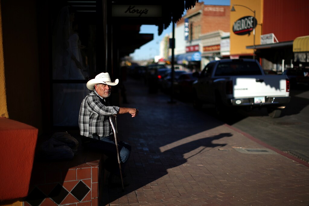 A man sits next to the U.S. border port with Mexico in Nogales, Arizona, U.S., January 31, 2017. Picture taken January 31, 2017. REUTERS/Lucy Nicholson - RTSYWAL