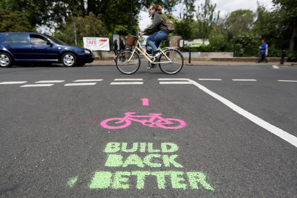 A cyclist cycles by painted stencils on a street to create pop up bike lanes in preparation for distanced bike rides, following the outbreak of the coronavirus disease (COVID-19), London, Britain, May 16, 2020