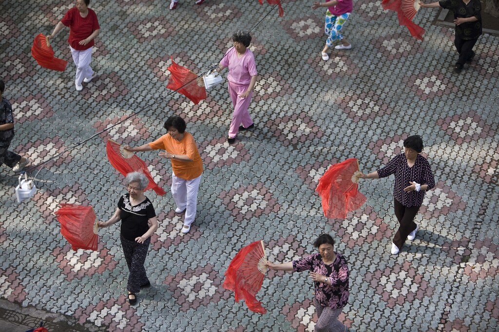Residents perform a traditional dance as part of a morning exercise in a park in Qingdao, Shandong province July 6, 2008. Qingdao, famous for its local beer and beaches will host the Sailing competitions of the Beijing 2008 Olympic Games as its still facing a huge algae bloom at the city's offshore waters just over a month before the beginning of the games. REUTERS/Nir Elias (CHINA) (BEIJING OLYMPICS 2008 PREVIEW) - RTX7OWK