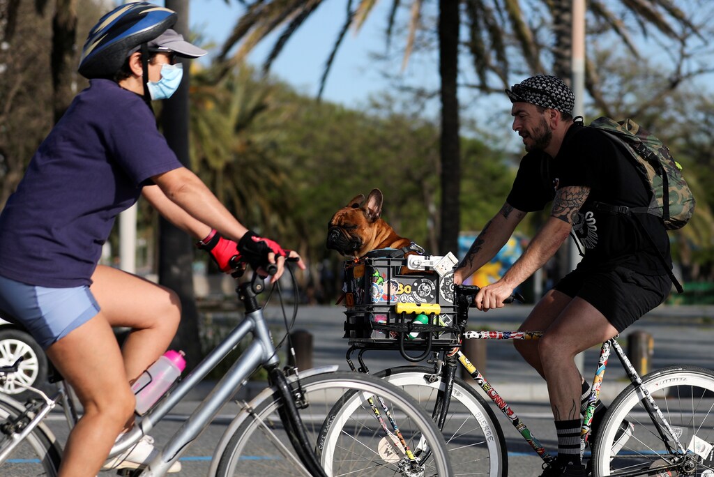 People ride bikes at the Barceloneta beach during the hours in which individual exercise is allowed outdoors, for the first time since the lockdown was announced, amid the coronavirus disease (COVID-19) outbreak, in Barcelona, Spain, May 2, 2020. REUTERS/Nacho Doce - RC29GG9AH8AS