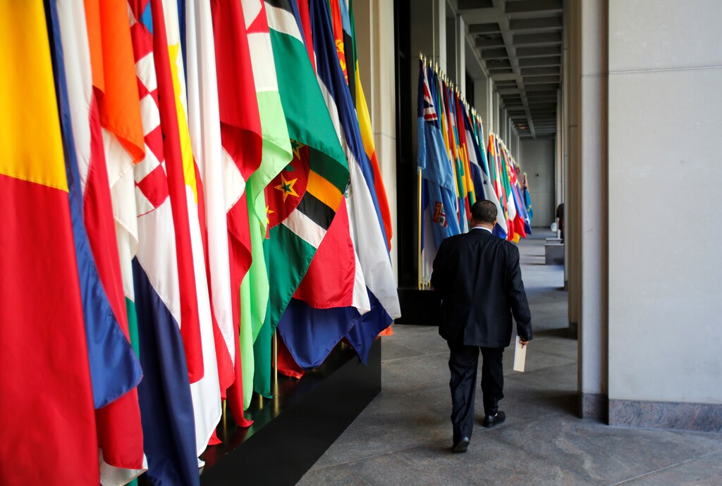 A delegate walks outside International Monetary Fund headquarters after closing of the IMF/World Bank annual meetings in Washington, U.S., October 9, 2016. REUTERS/Yuri Gripas - RTSRHRY