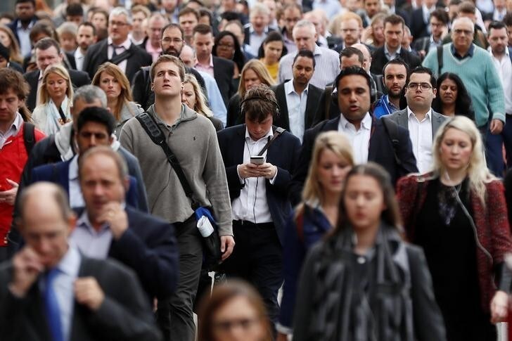 A commuter looks at his mobile phone as he crosses London Bridge during rush hour in London, Britain September 27, 2016. REUTERS/Stefan Wermuth SEARCH "WERMUTH PHONES" FOR THIS STORY. SEARCH "THE WIDER IMAGE" FOR ALL STORIES.