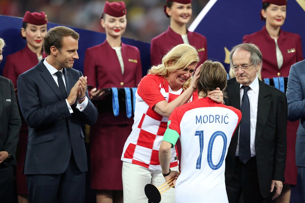 Soccer Football - World Cup - Final - France v Croatia - Luzhniki Stadium, Moscow, Russia - July 15, 2018 Croatia President Kolinda Grabar-Kitarovic speaks with Croatia's Luka Modric while President of France Emmanuel Macron looks on during the presentation. REUTERS/Carl Recine