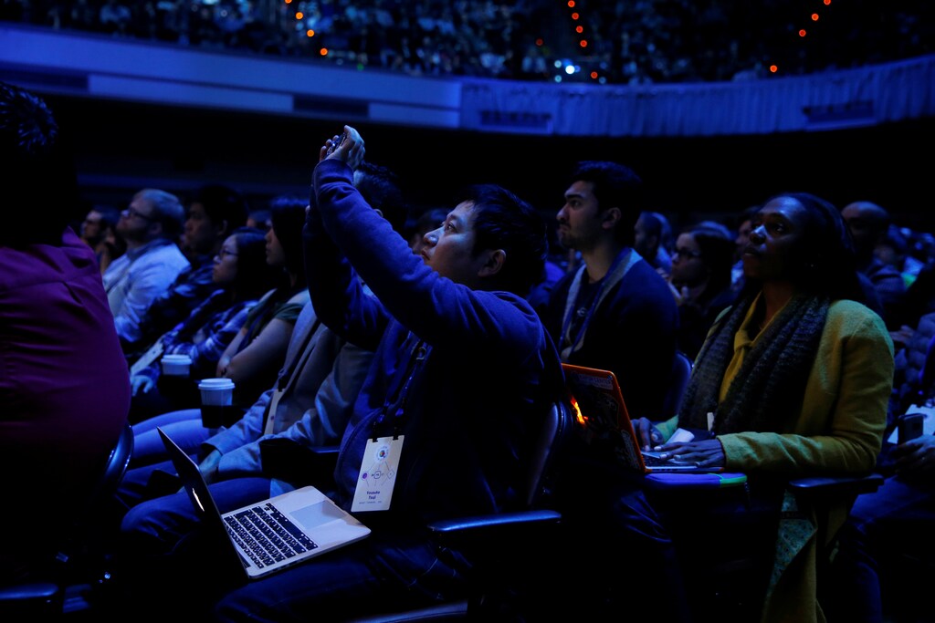 An attendee takes a photograph during a keynote on the second day of the annual Facebook F8 developers conference in San Jose, California, U.S., April 19, 2017. REUTERS/Stephen Lam - RTS130R3