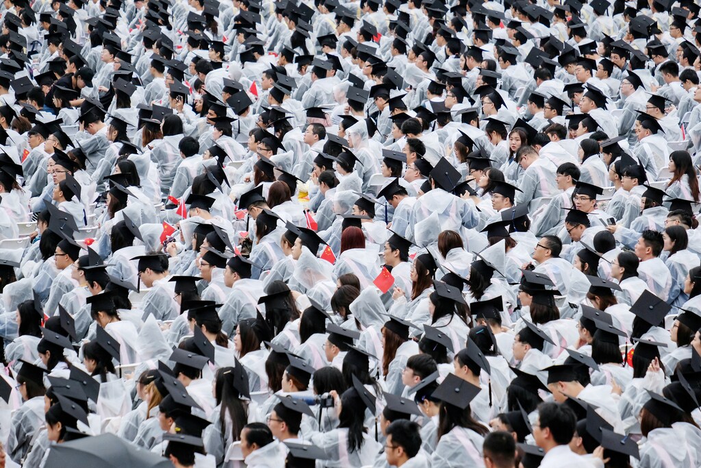 Students wearing raincoats attend their graduation ceremony at Wuhan University in Wuhan, Hubei province, China June 21, 2019. REUTERS/Stringer ATTENTION EDITORS - THIS IMAGE WAS PROVIDED BY A THIRD PARTY. CHINA OUT. TPX IMAGES OF THE DAY - RC19E9D19630