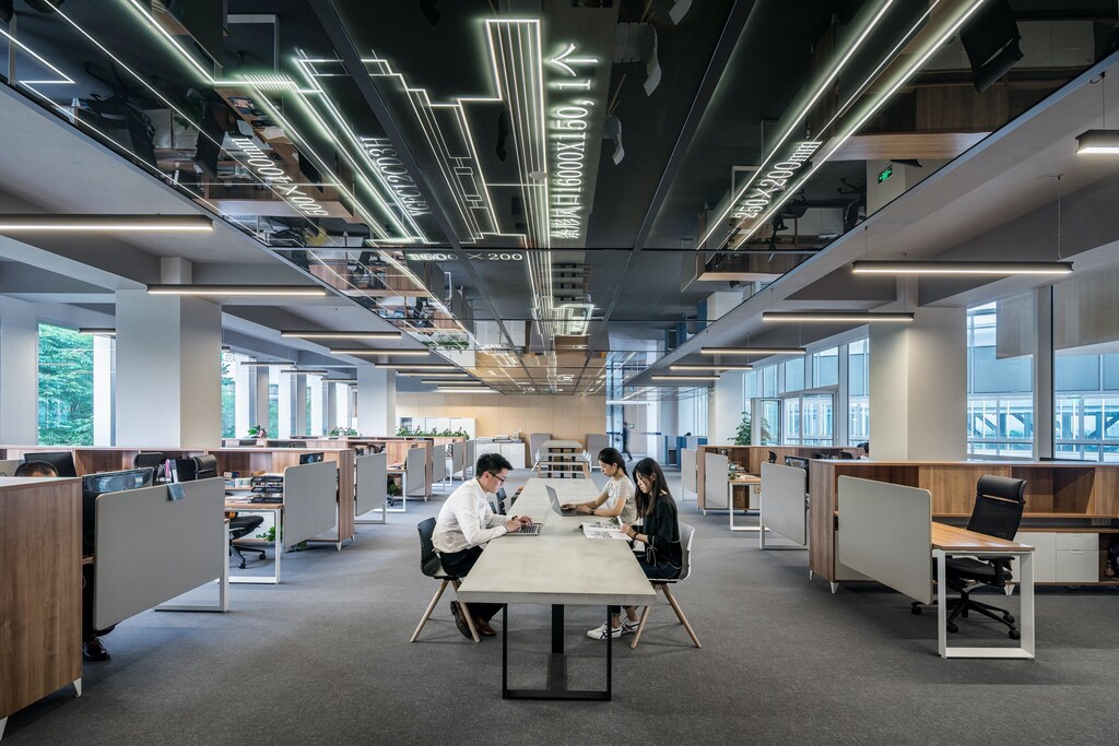 Employees sitting in an open plan modern office working