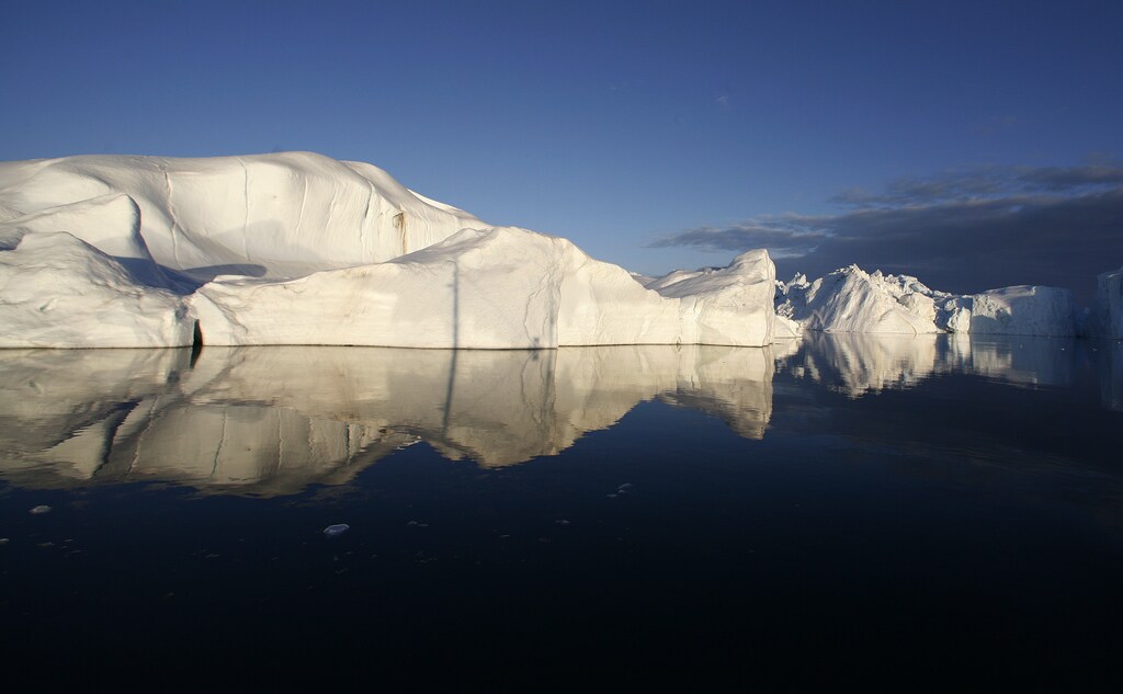 Icebergs are reflected in the calm waters at the mouth of the Jakobshavn ice fjord near Ilulissat in Greenland in this photo taken May 15, 2007.
