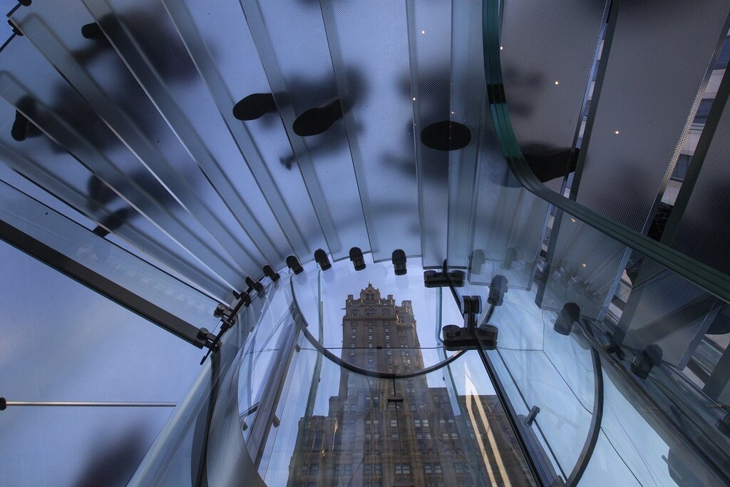 The Pierre building is seen through a stairway as customers enter the Apple retail store on Fifth Avenue in Manhattan, New York September 20, 2013. Apple Inc's newest smartphone models hit stores on Friday in many countries across the world, including Australia and China. REUTERS/Adrees Latif (UNITED STATES - Tags: BUSINESS TELECOMS) - RTX13SIP