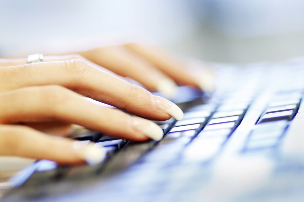 A woman uses a computer keyboard in this photo illustration taken in Sydney.