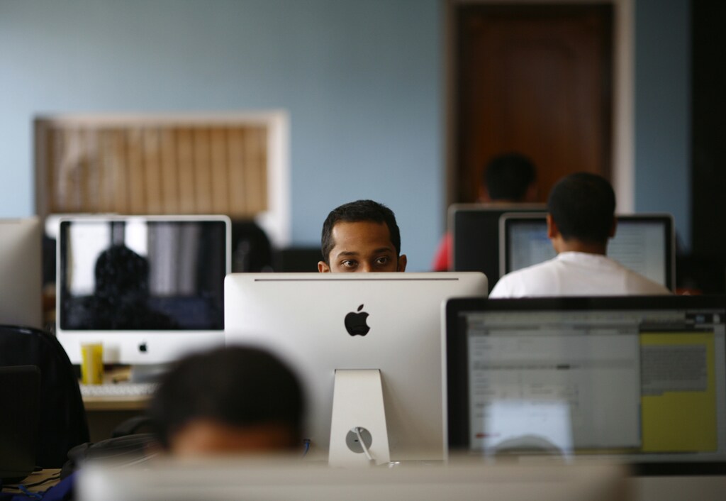 An employee works on his computer at the office of CloudFactory, a Canadian startup that based itself in Kathmandu, where it hires teams of Nepalese October 5, 2012. Not far from the world of regimented cubicles and headset-toting call centre operators, a quiet revolution is stirring in its slippers. While it's early days, proponents of so-called commercial crowdsourcing contend that a swelling army of global freelancers is already disrupting traditional outsourcing - from preparing tax statements to conducting research on pediatricians. Picture taken October 5, 2012. To match story ASIA-FREELANCE/ REUTERS/Navesh Chitrakar (NEPAL) - RTR39016