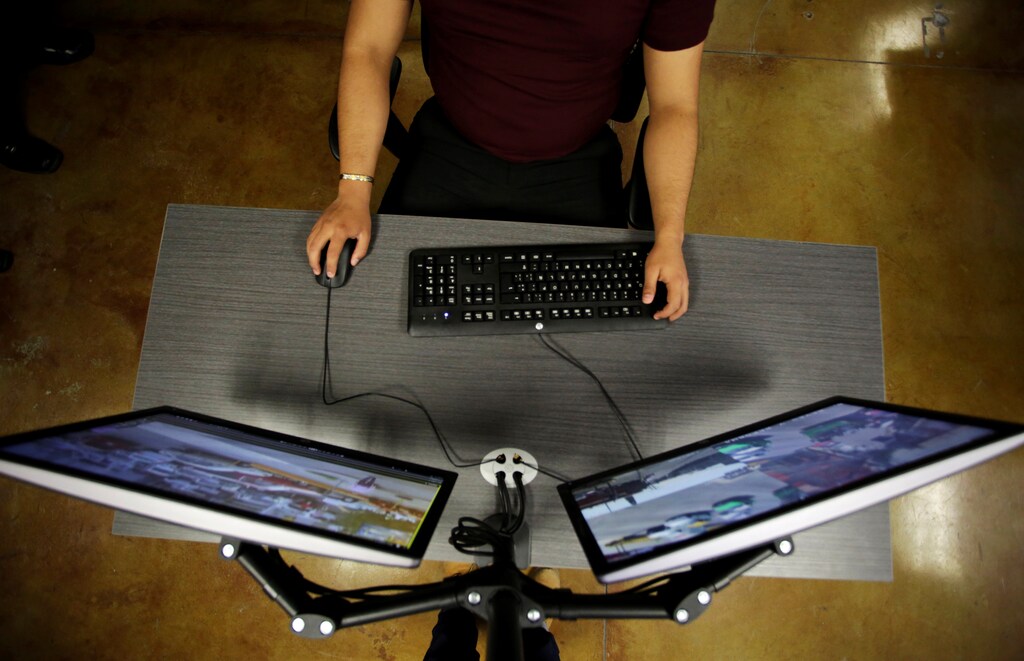 An officer observes computer screens displaying images from cameras monitoring traffic condition, general monuments and public areas, at the Office of Public Security and Traffic in Monterrey, Mexico June 6, 2018. Picture taken on June 6, 2018. REUTERS/Daniel Becerril - RC1746BE86C0