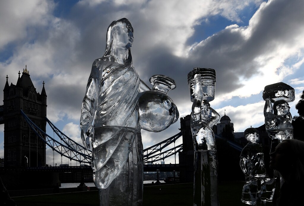 Ice sculptures depicting people walking to collect clean water are seen as environmental and public health campaign group WaterAid highlights the threat posed globally by climate change to healthy water supplies, near Tower Bridge, in London, Britain, September 15, 2021. REUTERS/Toby Melville - RC28QP9HEO58
