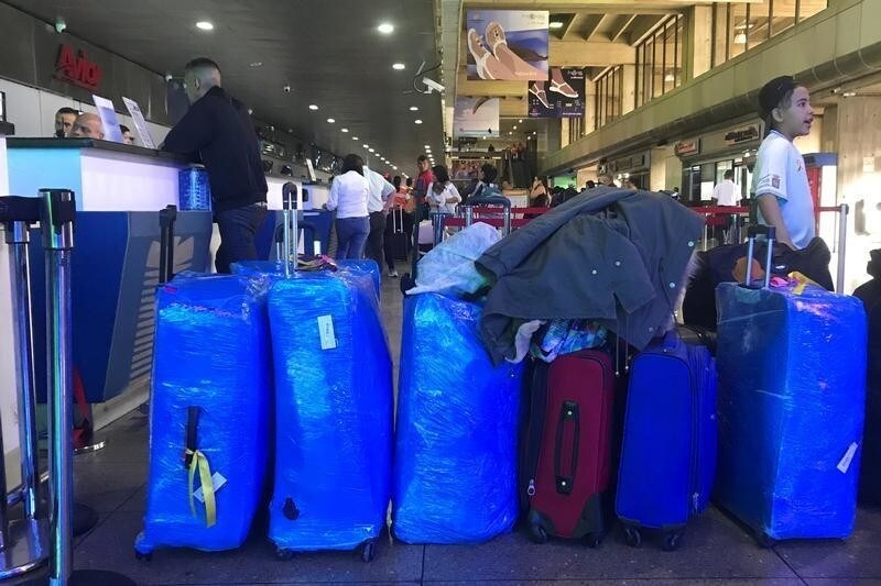 Suitcases wrapped in plastic cling film are seen lined up in the departures hall at Simon Bolivar airport in Caracas, Venezuela July 2, 2018. Picture taken July 2, 2018.