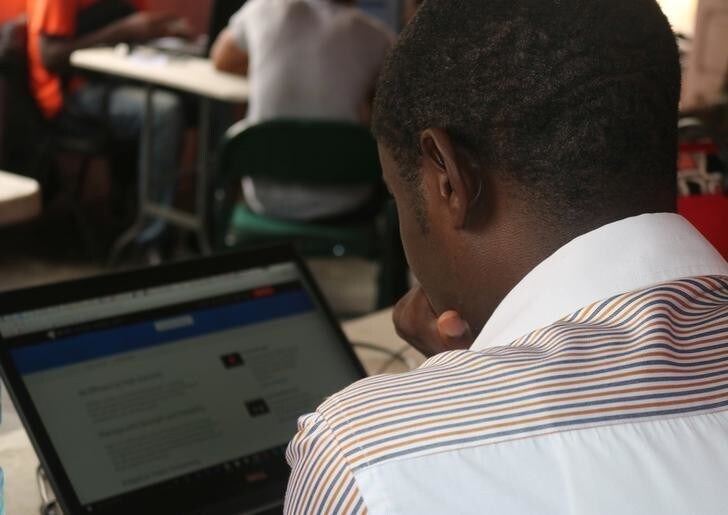 Young startup promoters work on their computers in New Bonako village, Cameroon March 28, 2017 2017. Picture taken March 28, 2017. REUTERS/Stringer