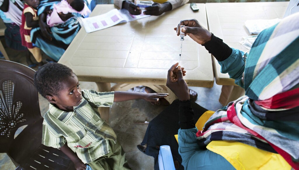 A child receives a meningitis vaccination at the community center in the Al Neem camp for Internally Displaced People in El Daein, East Darfur October 8, 2012.