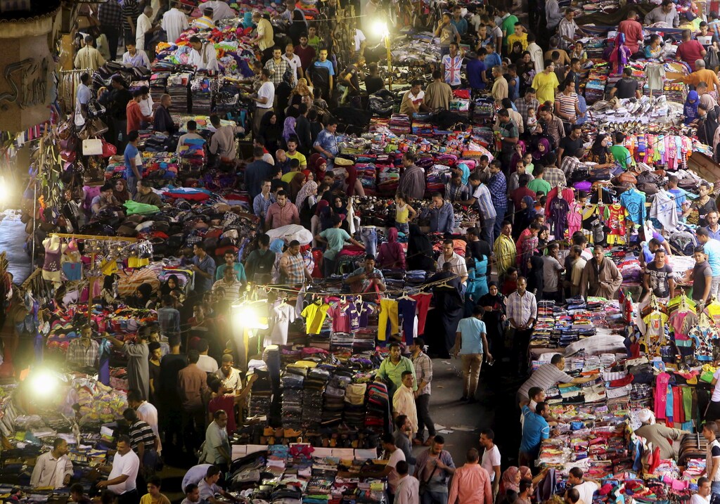 People shop at Al Ataba, a popular market in downtown Cairo, July 15, 2015. Muslims across the world are preparing to celebrate the Eid al-Fitr festival at the end of the holy month of Ramadan. REUTERS/Mohamed Abd El Ghany TPX IMAGES OF THE DAY - RTX1KGXK
