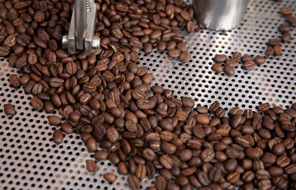 Coffee beans are seen in a roaster at a stand at the Coffee Fair in Lima, Peru, August 25, 2017.