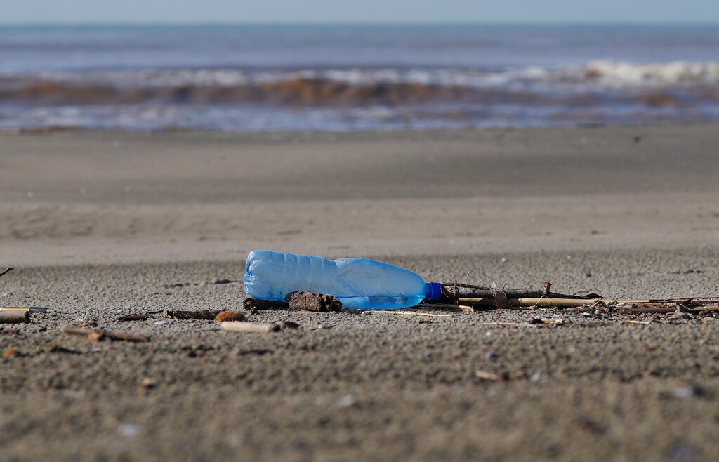 A plastic bottle lies on the sand at Maccarese beach, west of Rome, Italy. REUTERS/Max Rossi