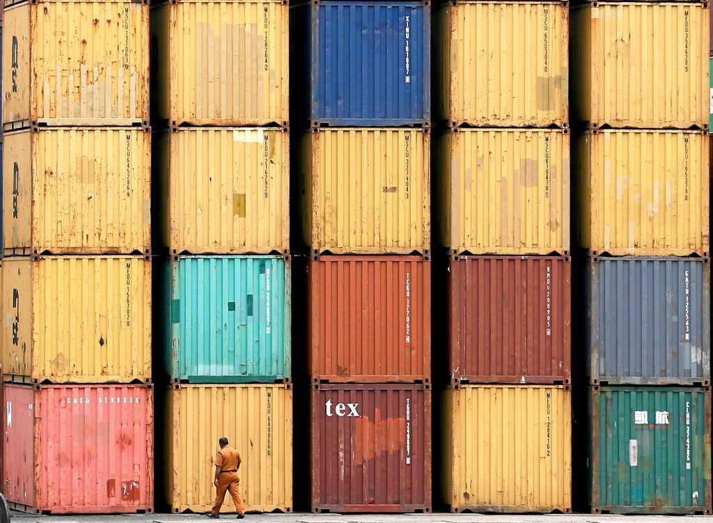 A security officer walks past a shipping containers at the main Sri Lankan port in Colombo, Sri Lanka April 2, 2018. REUTERS/ Dinuka Liyanawatte - RC14764195A0