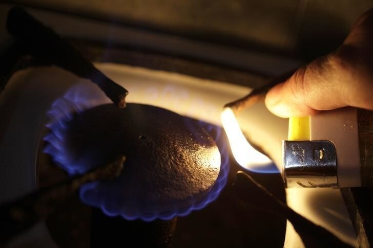 Cuban farmer Daniel Garcia, lights a bio-gas stove at his farm in the province of Pinar del Rio in Western Cuba October 6, 2012. Garcia is getting more out of his pigs than he ever thought possible by turning their manure into a biogas -- methane and carbon dioxide -- that he and his neighbours use for cooking. It's a relatively old technology that's new to Cuba where the government is promoting development of renewable fuel sources. Daniel fills up bags with the gas and gives them at no cost to his neighbors, who say it's a welcome gift that enables them to prepare food even during the frequent electricity blackouts in their area.