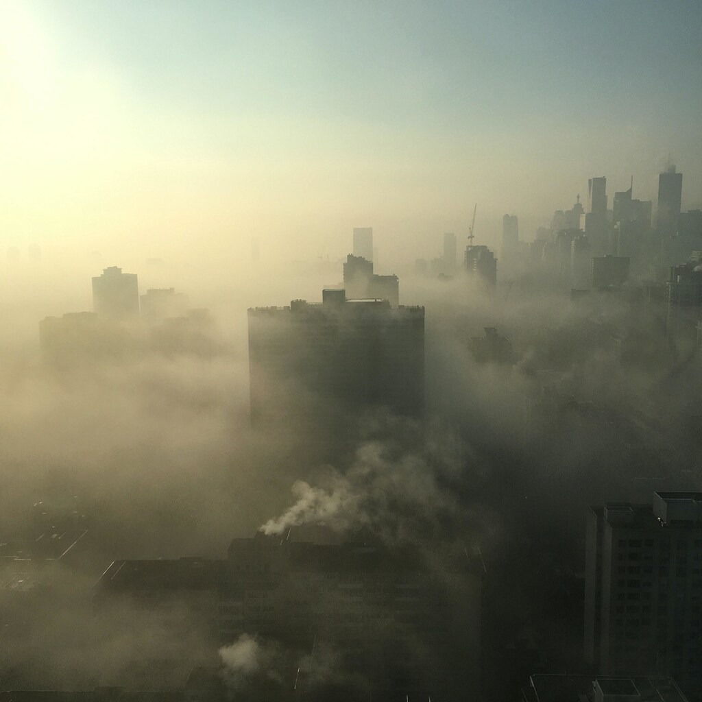 The image shows a city swathed in polluted air to illustrate the dangers of air pollution