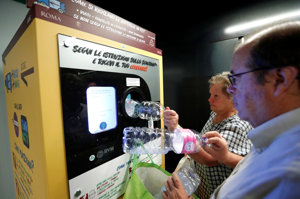People put plastic bottles into a recycling machine in San Giovanni metro station in Rome, Italy September 27, 2019. Picture taken September 27, 2019. REUTERS/Remo Casilli - RC198D157BC0
