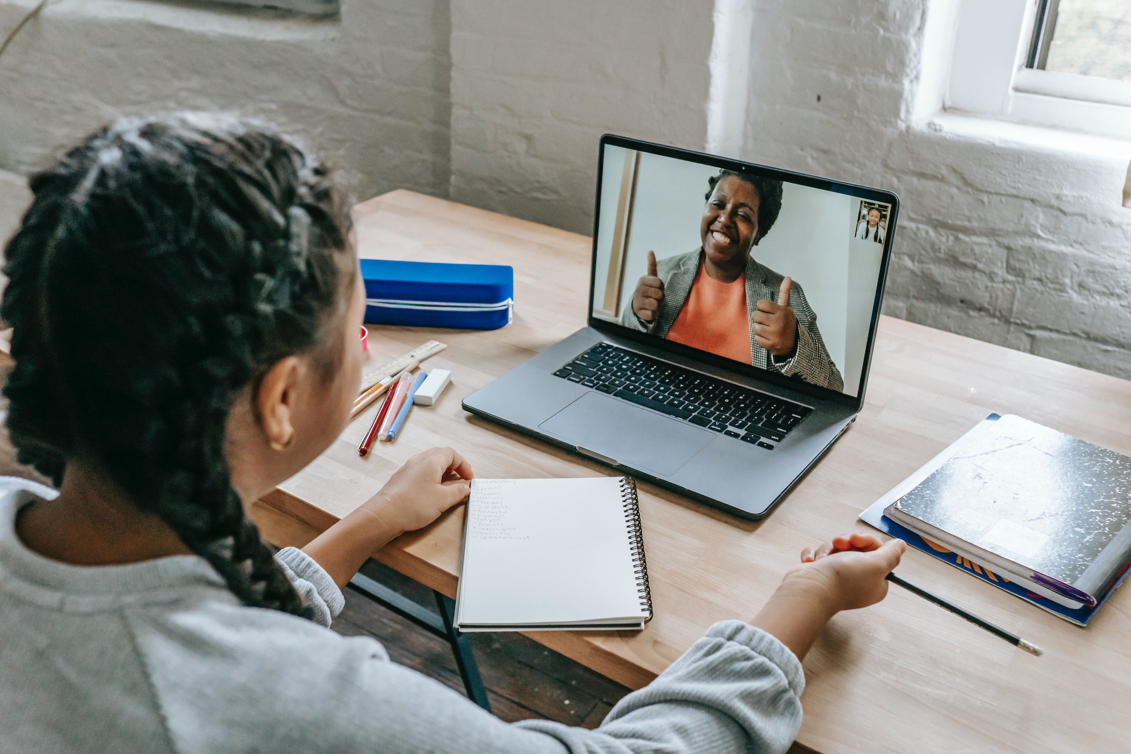 digital inclusion - young girl on video call with teacher.