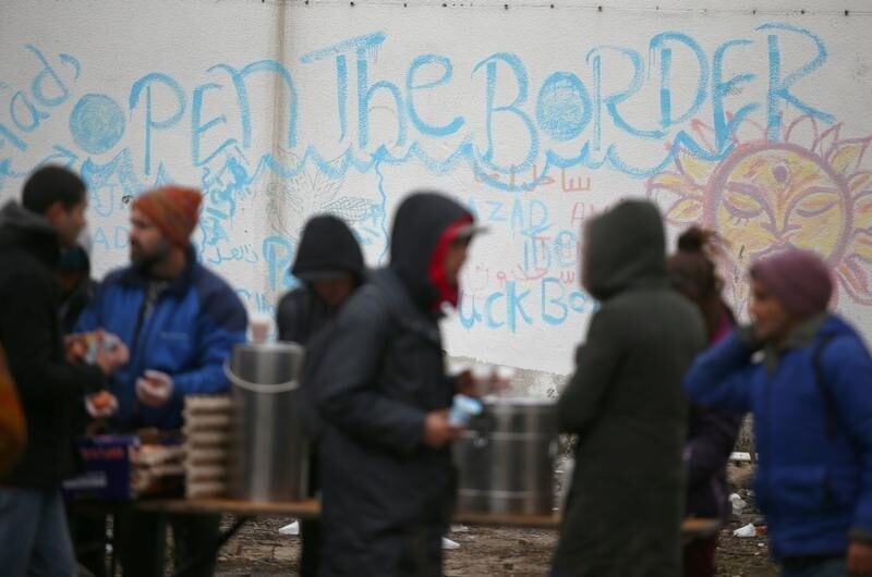 Migrants are taking free food inside an abandoned factory close to the Croatian border near the town of Sid, Serbia, December 19, 2017. Picture taken December 19, 2017 REUTERS/Djordje Kojadinovic - RC1E50B23A80