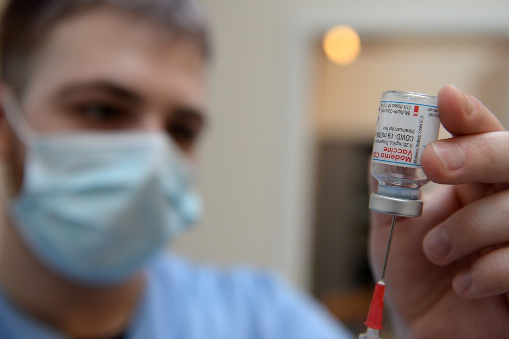 A medical worker prepares a syringe with a dose of the Moderna COVID-19 vaccine at a vaccination center in Brussels as part of the coronavirus disease (COVID-19) vaccination campaign in Belgium.