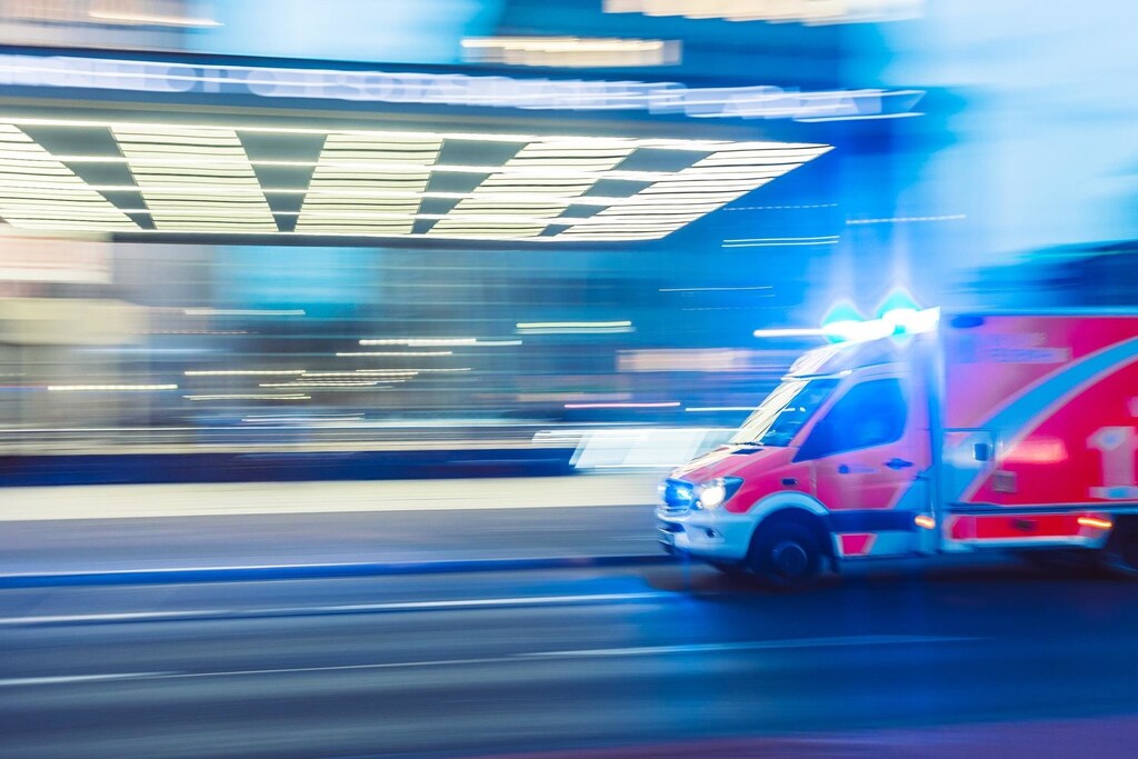 An ambulance speeding down a road - public-private partnerships can give more people better health care
