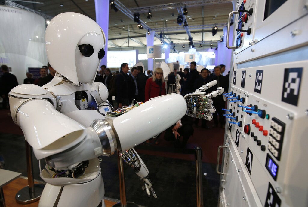 The humanoid robot AILA (artificial intelligence lightweight android) operates a switchboard during a demonstration by the German research centre for artificial intelligence at the CeBit computer fair in Hanover March, 5, 2013. The biggest fair of its kind open its doors to the public on March 5 and will run till March 9, 2013. REUTERS/Fabrizio Bensch (GERMANY - Tags: BUSINESS SCIENCE TECHNOLOGY) - RTR3ELOF